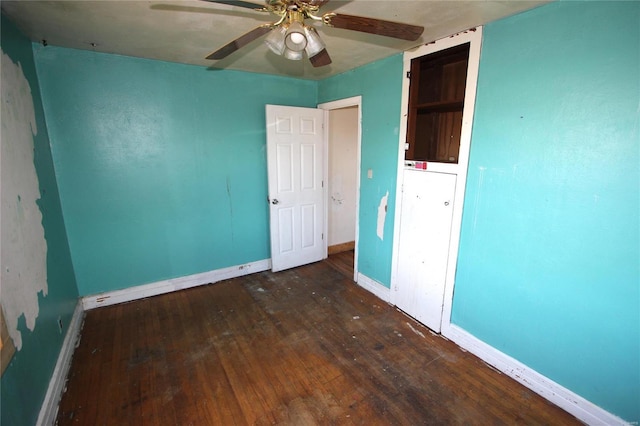 unfurnished bedroom with ceiling fan and dark hardwood / wood-style flooring