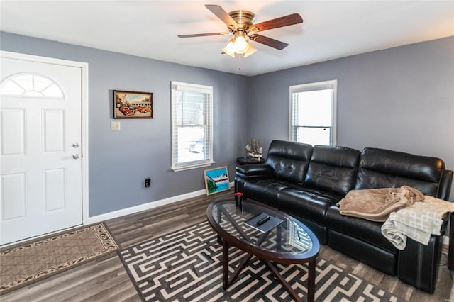 living room featuring dark hardwood / wood-style floors and ceiling fan