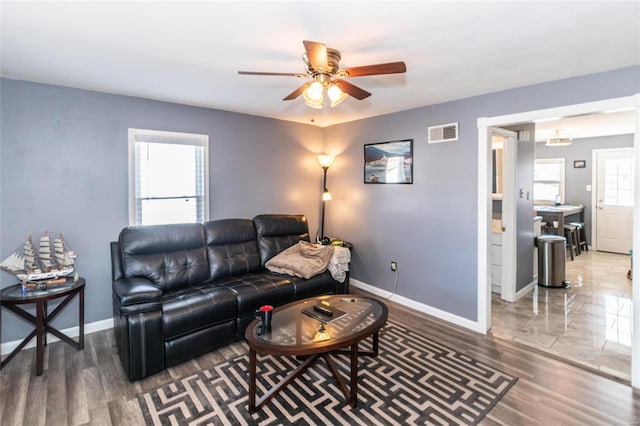 living room with dark hardwood / wood-style floors and ceiling fan