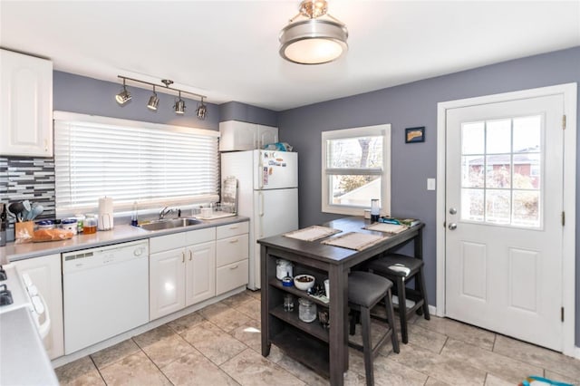 kitchen featuring white cabinetry, white appliances, sink, and decorative backsplash