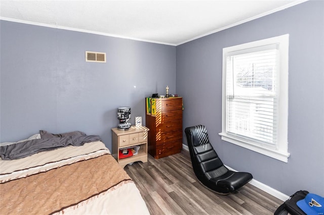 bedroom featuring hardwood / wood-style flooring and ornamental molding