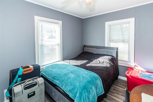 bedroom with crown molding, ceiling fan, dark hardwood / wood-style flooring, and multiple windows