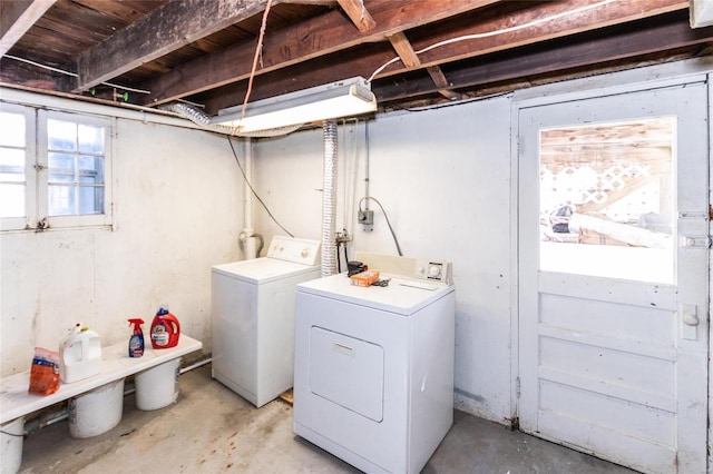 clothes washing area featuring washer and clothes dryer