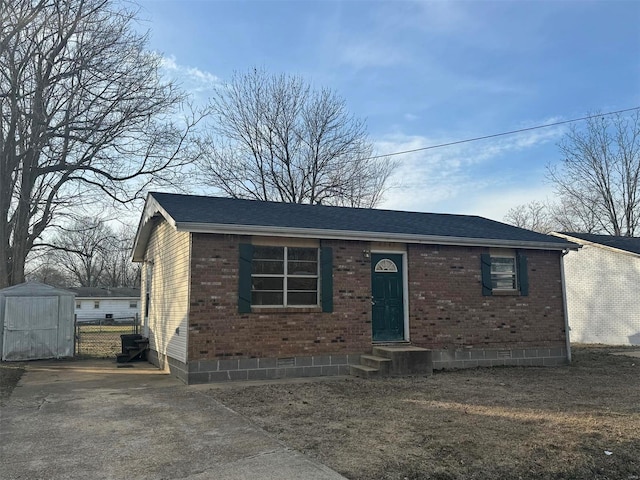 view of front of house with a storage shed