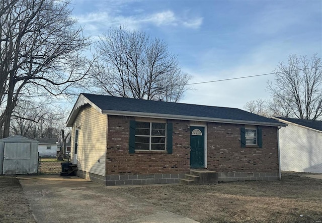 view of front of property with a shed