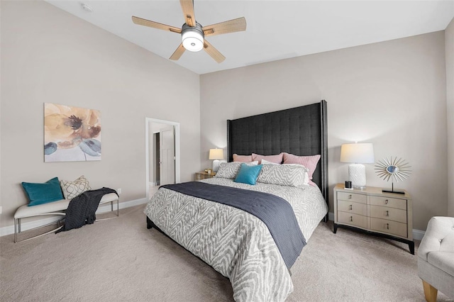 bedroom featuring ceiling fan, light colored carpet, and vaulted ceiling