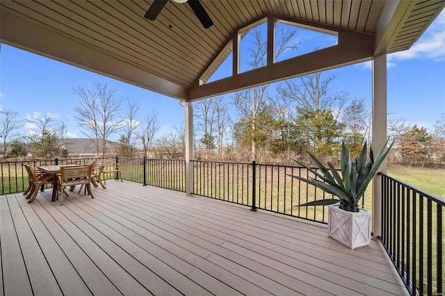 wooden deck with ceiling fan and a yard