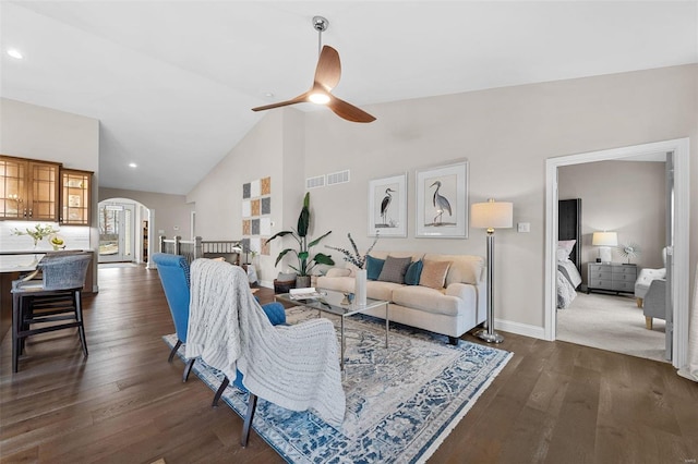 living room featuring ceiling fan, dark hardwood / wood-style flooring, and high vaulted ceiling