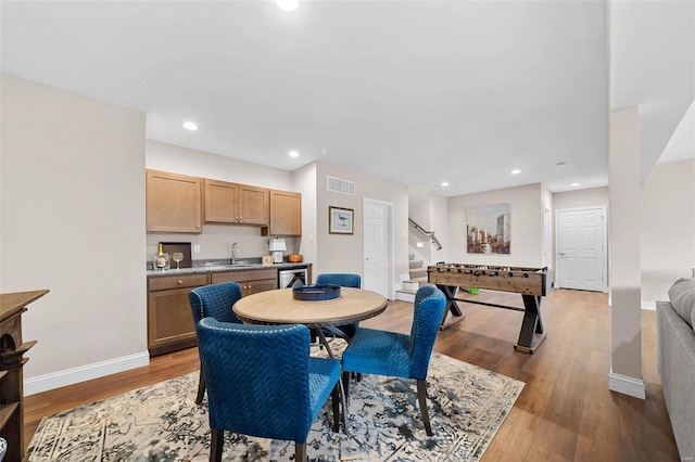 dining room with sink and light hardwood / wood-style flooring