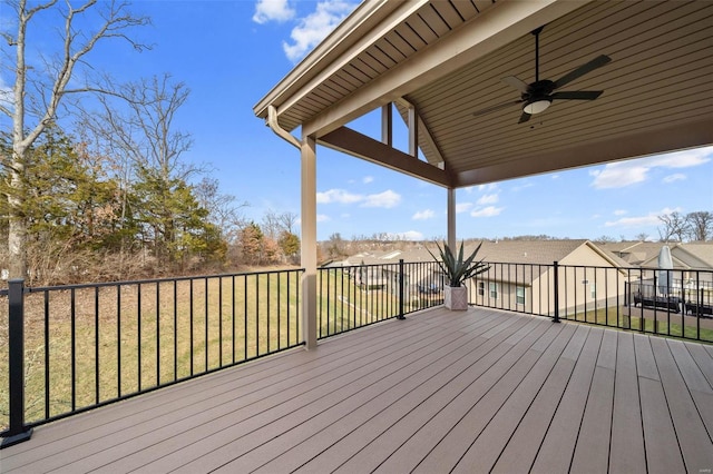 wooden deck with ceiling fan and a yard