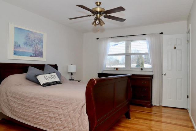 bedroom with ceiling fan and light hardwood / wood-style flooring