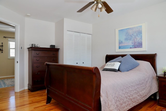 bedroom with light hardwood / wood-style floors, a closet, and ceiling fan