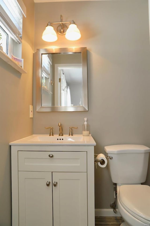 bathroom featuring vanity and toilet