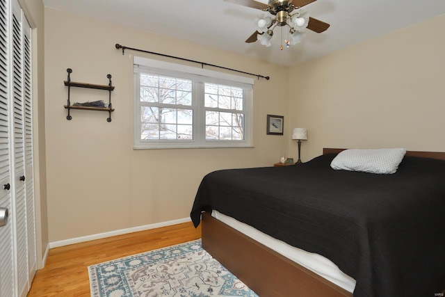 bedroom featuring ceiling fan, light hardwood / wood-style floors, and a closet