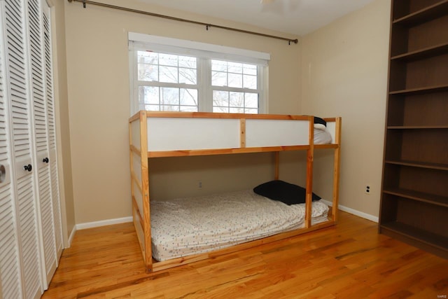 unfurnished bedroom featuring hardwood / wood-style floors and a closet