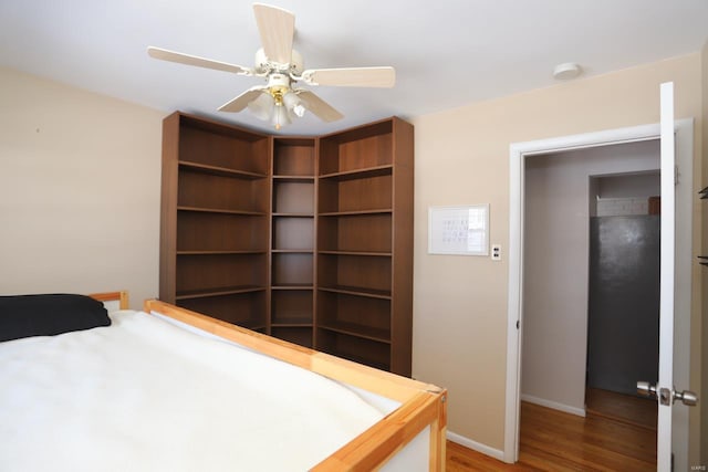 bedroom with hardwood / wood-style floors and ceiling fan