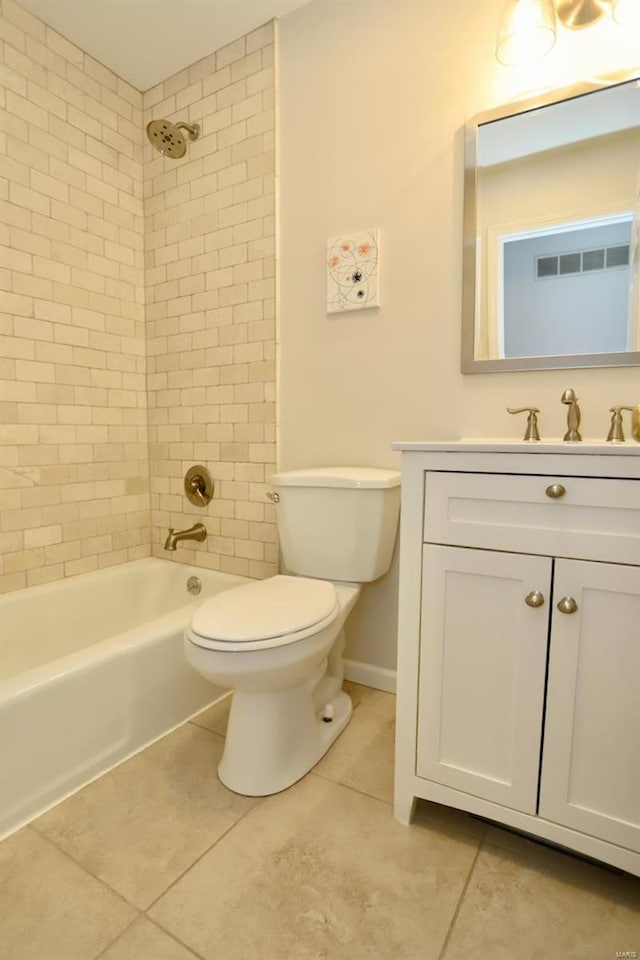 full bathroom featuring vanity, tile patterned floors, toilet, and tiled shower / bath