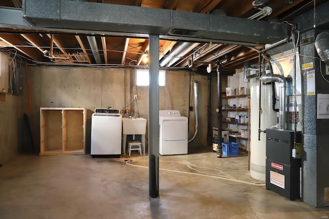 basement with sink and washing machine and dryer