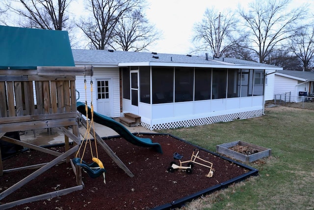 back of house with a playground, a sunroom, and a yard