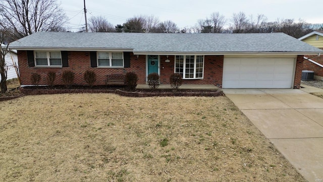 single story home featuring a garage, central AC, and a front yard