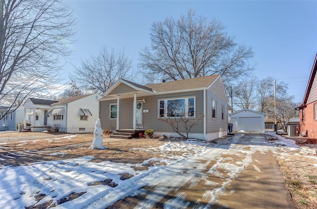 bungalow featuring a garage and an outbuilding