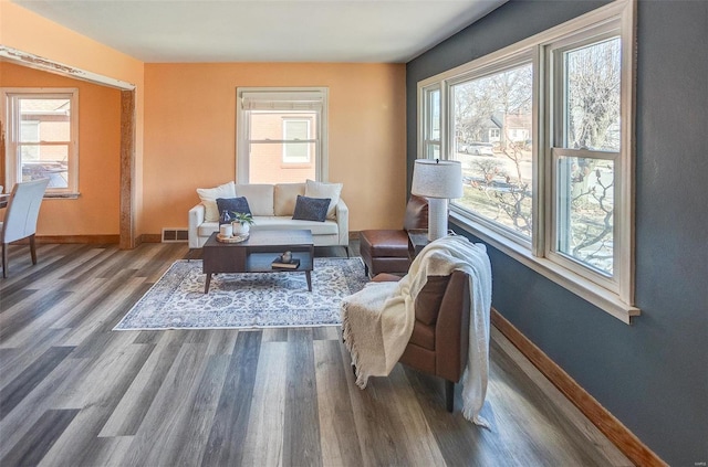 sitting room with dark wood-type flooring