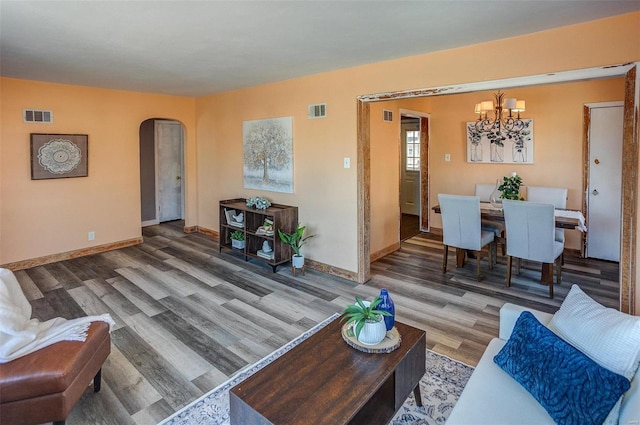 living room featuring a chandelier and hardwood / wood-style floors