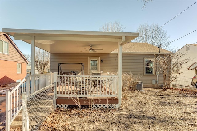 rear view of house with a deck, central AC unit, and ceiling fan