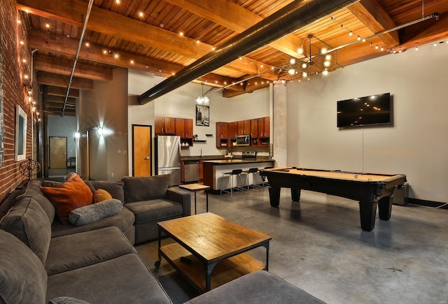 living room with concrete flooring, beam ceiling, wooden ceiling, and a towering ceiling