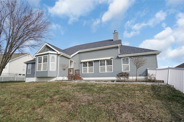 rear view of house with a yard