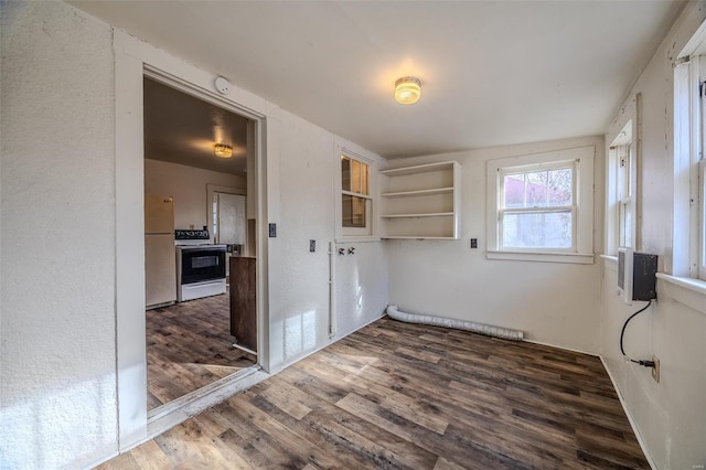 unfurnished room with dark wood-type flooring