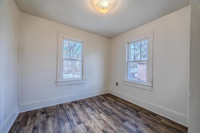 unfurnished room with dark hardwood / wood-style flooring and a healthy amount of sunlight