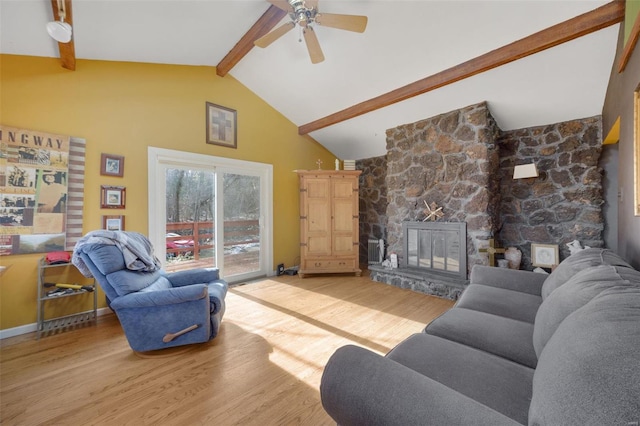 living room with a stone fireplace, high vaulted ceiling, light wood-type flooring, beamed ceiling, and baseboards