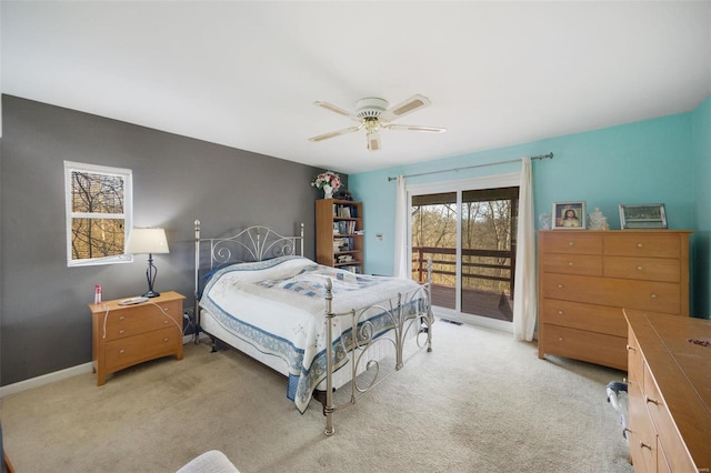 bedroom featuring light carpet, access to exterior, ceiling fan, and multiple windows