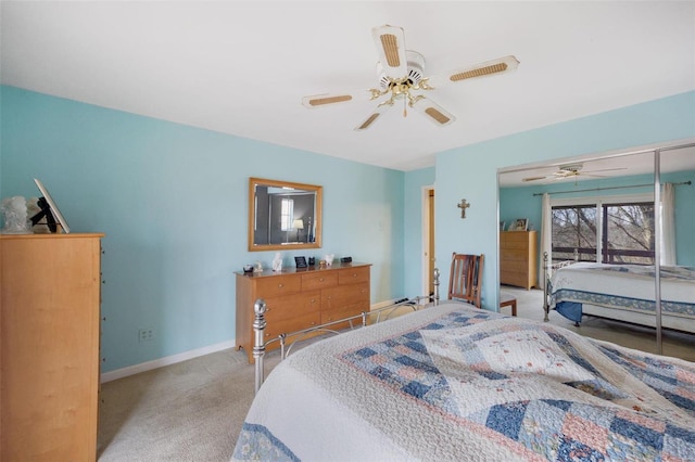 bedroom featuring light carpet, a ceiling fan, and baseboards