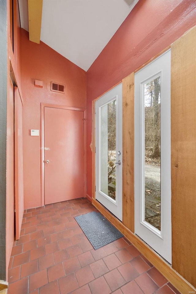 doorway with visible vents and vaulted ceiling