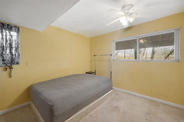 bedroom with a ceiling fan, light colored carpet, and baseboards