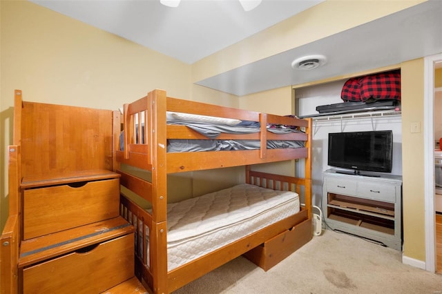 bedroom with visible vents and light carpet