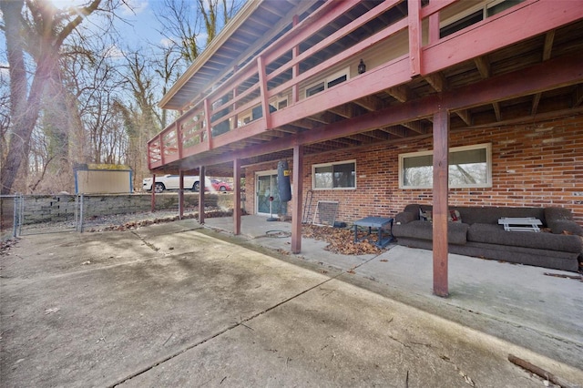 rear view of house featuring a patio area and brick siding