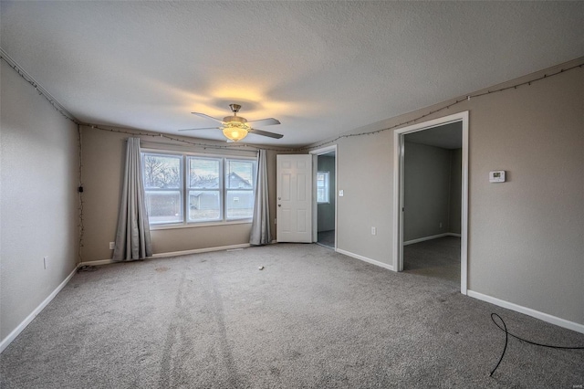 spare room with ceiling fan, carpet, and a textured ceiling