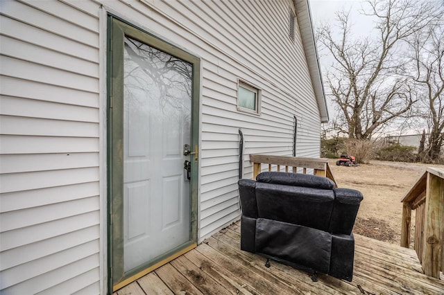 view of exterior entry featuring a wooden deck