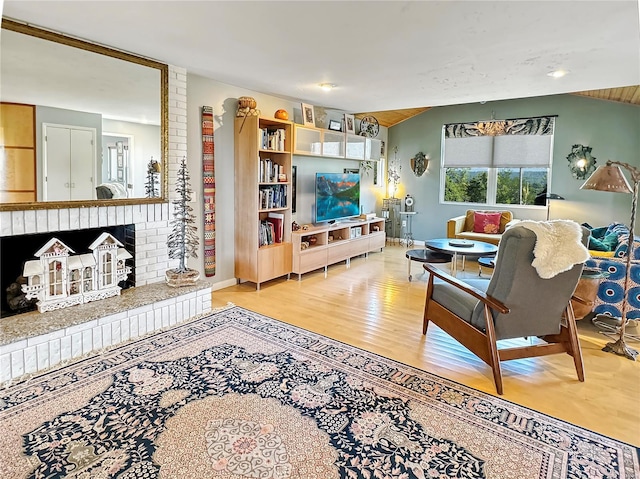 living room with hardwood / wood-style flooring and a fireplace