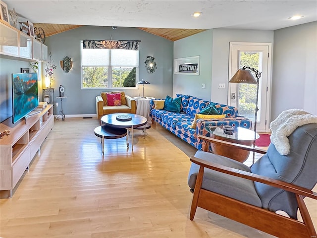 living room featuring lofted ceiling, wooden ceiling, a healthy amount of sunlight, and light wood-type flooring