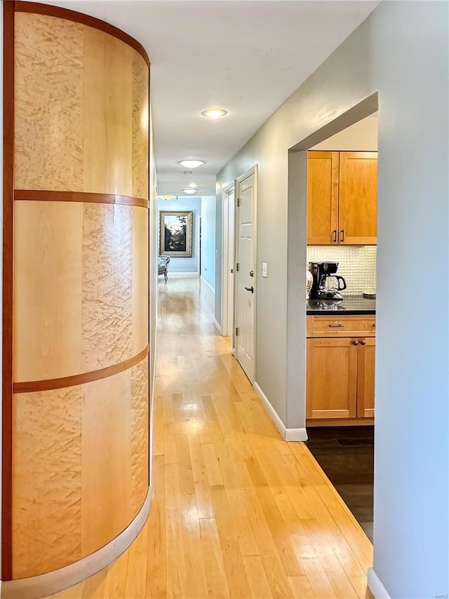 corridor with light hardwood / wood-style floors