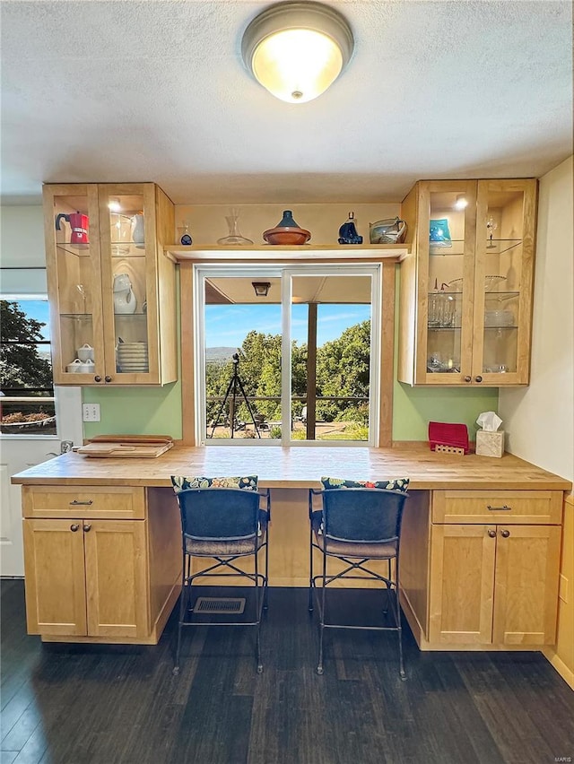 kitchen with dark hardwood / wood-style flooring, butcher block countertops, and a textured ceiling