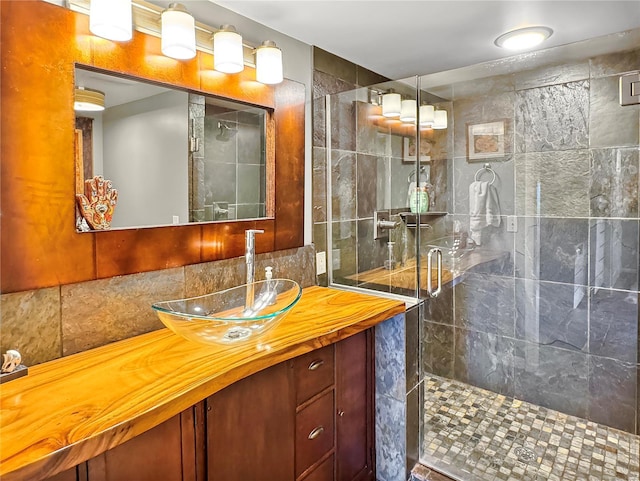 bathroom featuring vanity and a shower with shower door