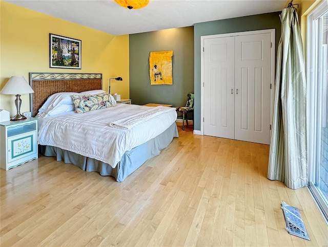 bedroom with a closet and light hardwood / wood-style flooring