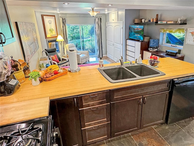 kitchen with sink, dark brown cabinets, and black dishwasher