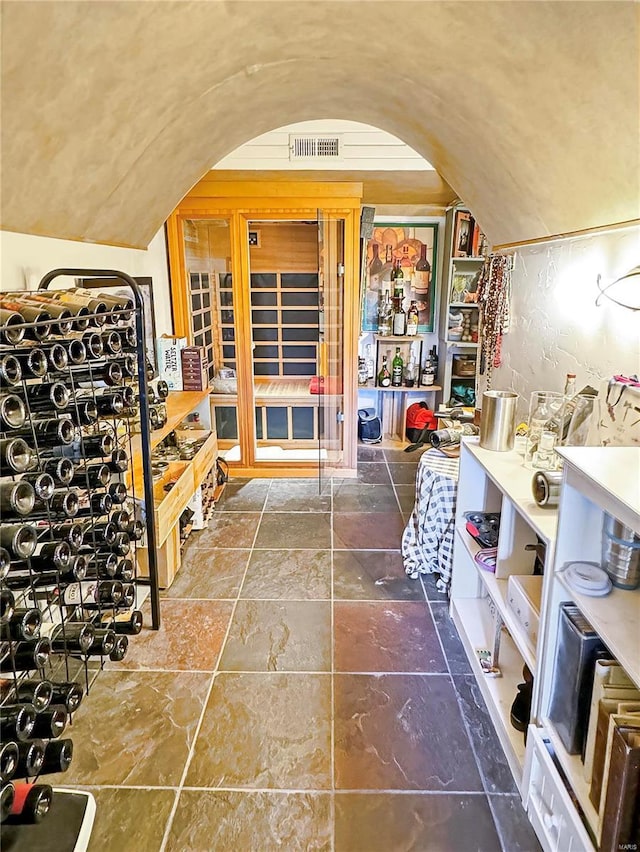 wine room featuring lofted ceiling