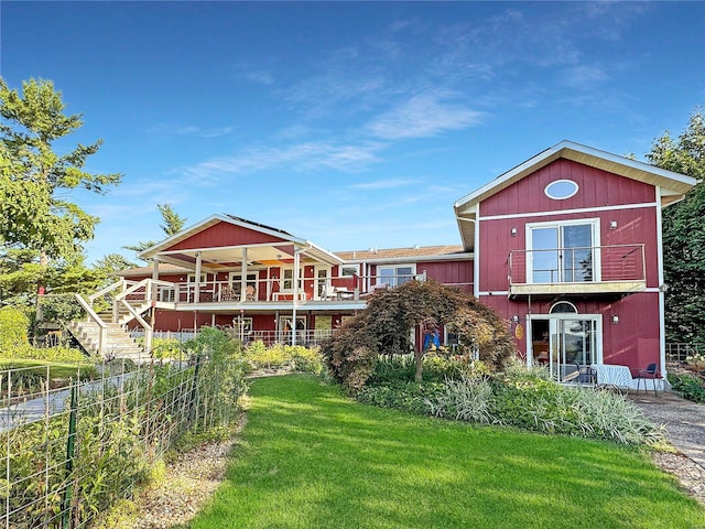 rear view of property featuring a yard